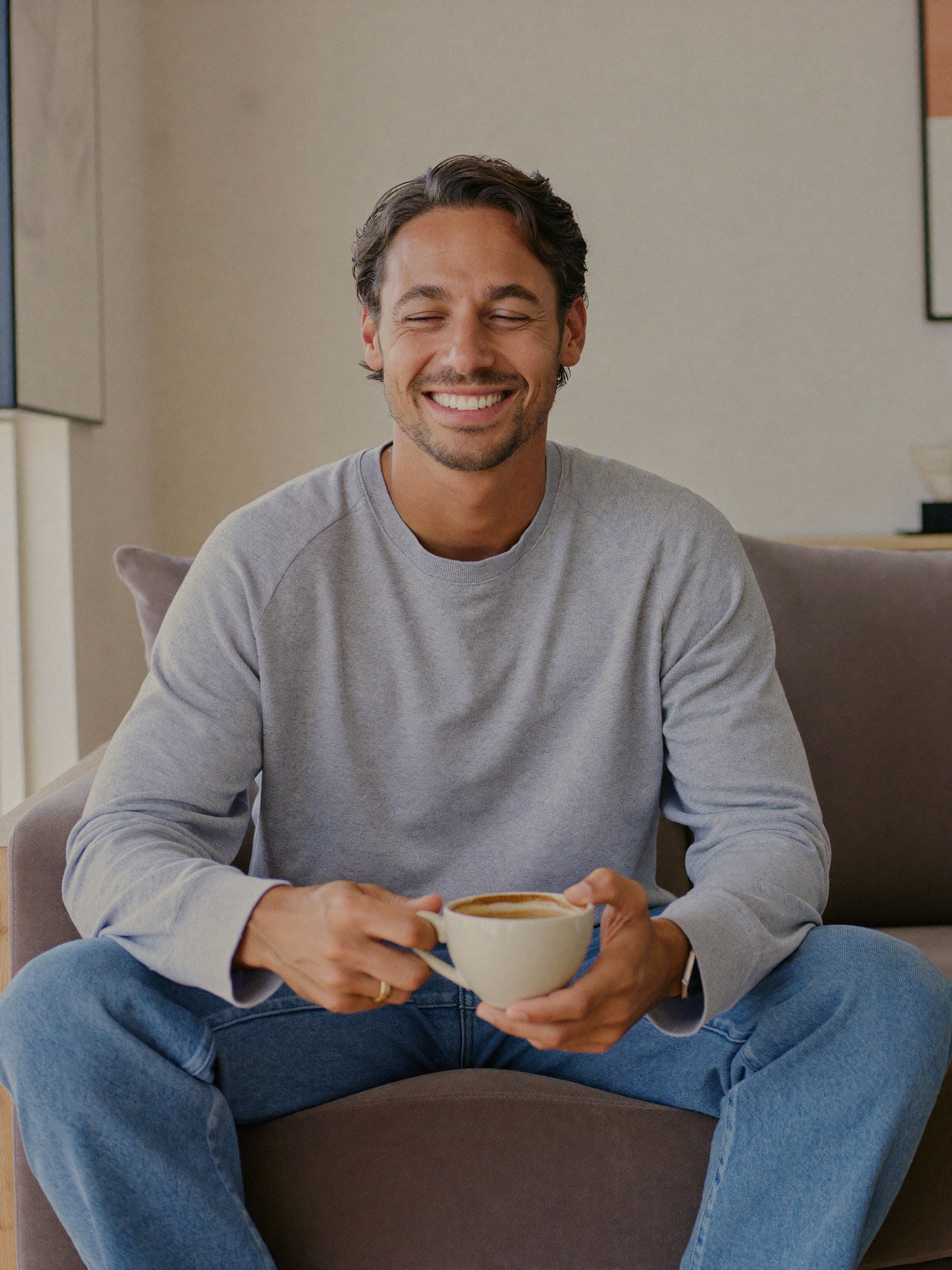 A calm man resting comfortably at home during a light recovery, fully dressed
