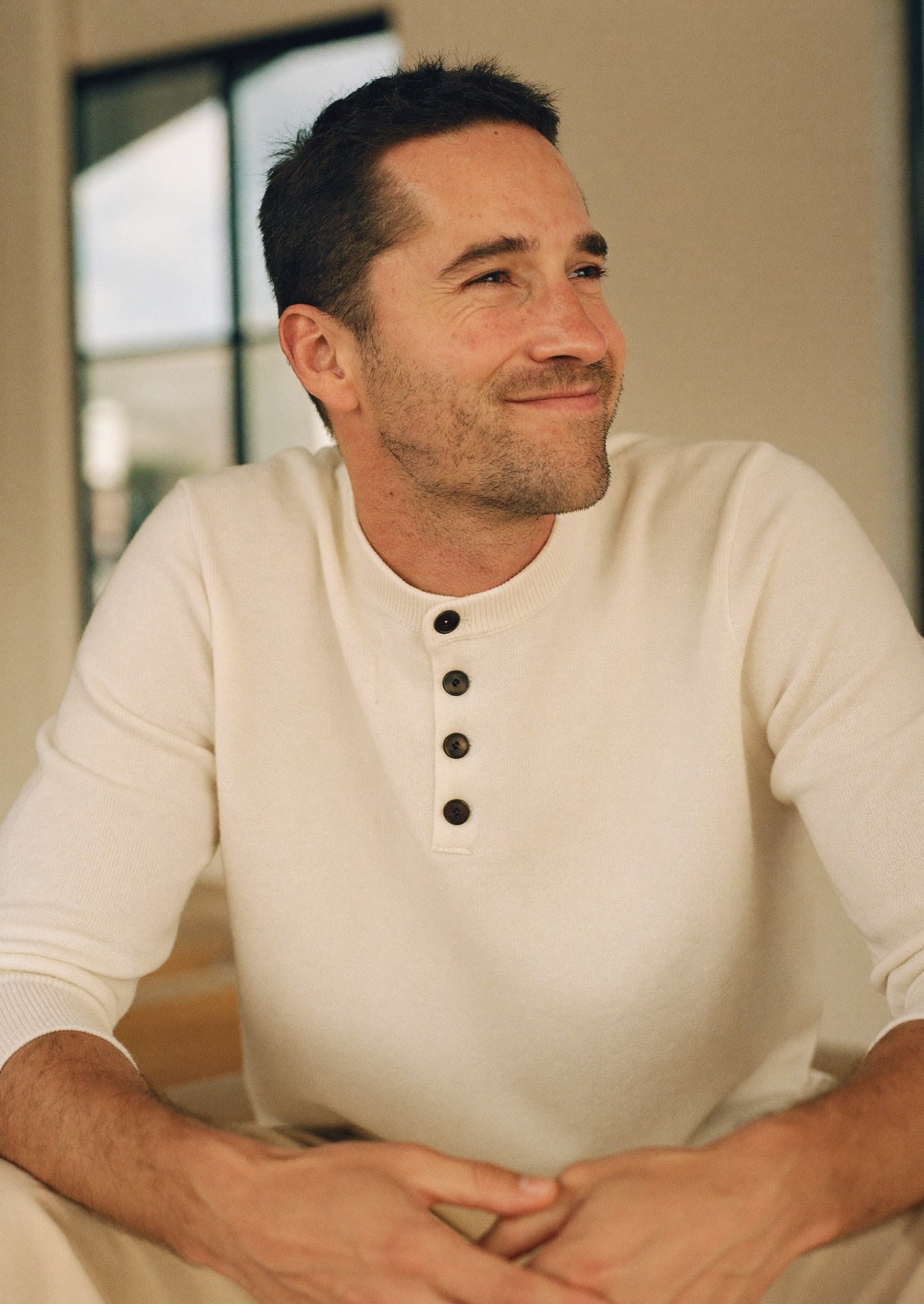 A relaxed, confident man at ease in natural light